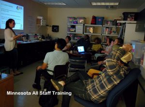 Minnesota All-Staff training, team watching presentation.
