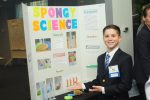 Student poses infront of Spongy Science experiment.